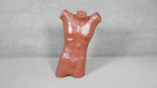 A brown leather covered fibre glass male torso mannequin. H.80 W.50 D.24cm