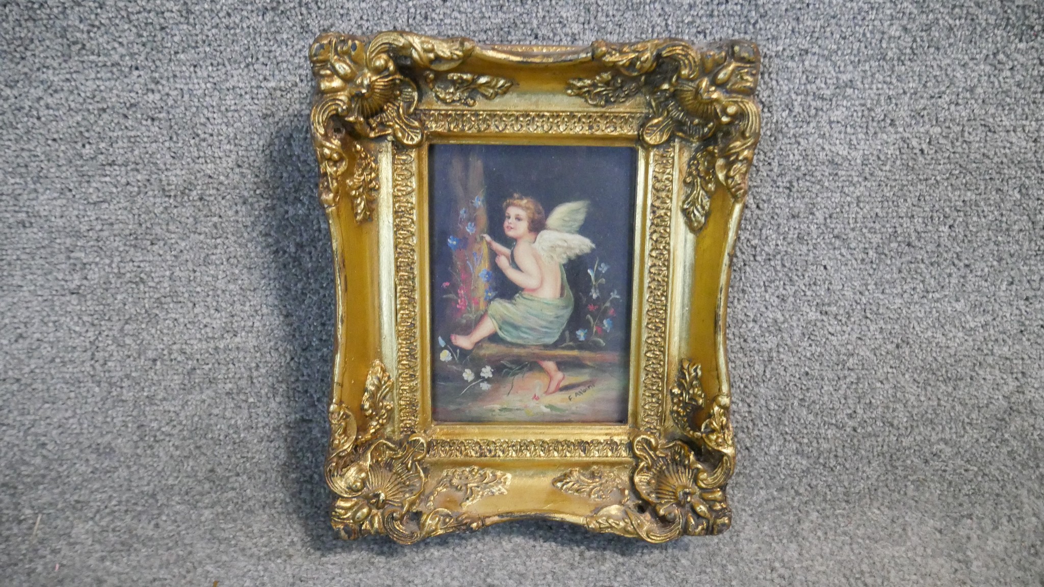A 19th century carved gilt framed oil on board of a winged putti sitting in a wood with flowers. - Image 2 of 5