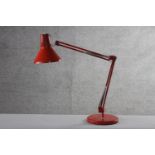 A mid-century Danish red painted anglepoise style lamp by HCF. Impressed makers mark to base. H.84