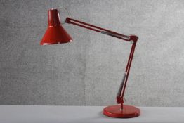 A mid-century Danish red painted anglepoise style lamp by HCF. Impressed makers mark to base. H.84