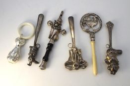 Six silver rattles. Including a rooster rattle with bone teether, a bear and rabbit rattle, one of