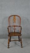 A 19th century elm Windsor armchair with pierced and carved central splat on turned and