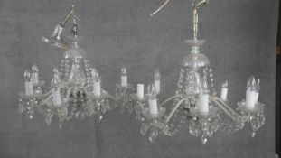 A pair of vintage cut crystal and cane glass eight branch chandeliers with hanging crystal drops and