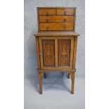 A late 19th century amboyna, walnut and ebony bijouterie cabinet fitted with drawers to the upper