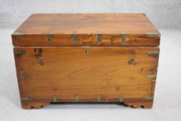 A teak and brass bound chest with fitted interior and twin carrying handles. H.47 W.78 D.47 cm (