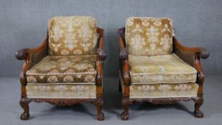 A pair of mid century carved walnut bergere armchairs with double caned sides in cut floral