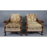 A pair of mid century carved walnut bergere armchairs with double caned sides in cut floral