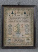 A framed and glazed Victorian hand embroidered sampler by Anne Robinson at the age of ten.