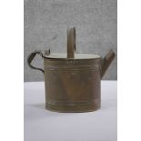 A Victorian HENRY LOVERIDGE & CO brass watering can with ridged design and hinged lid. Makers mark