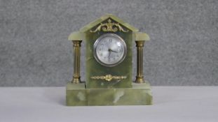 A vintage architectural style green alabaster mantle clock with gilt metal columns and ormolu