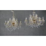A pair of vintage brass and cut crystal twelve branch chandeliers with crystal swags and drops. H.60