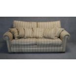 A contemporary two seater sofa in floral striped upholstery.