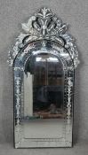 A Venetian style pier mirror with shaped bevelled plate within etched foliate cresting and