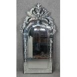 A Venetian style pier mirror with shaped bevelled plate within etched foliate cresting and