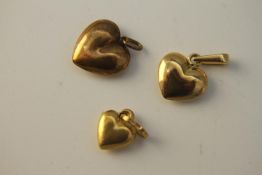 Three 3D 14 carat yellow gold heart charms. Each a different size. Each stamped 585. Weight. 2.4g.