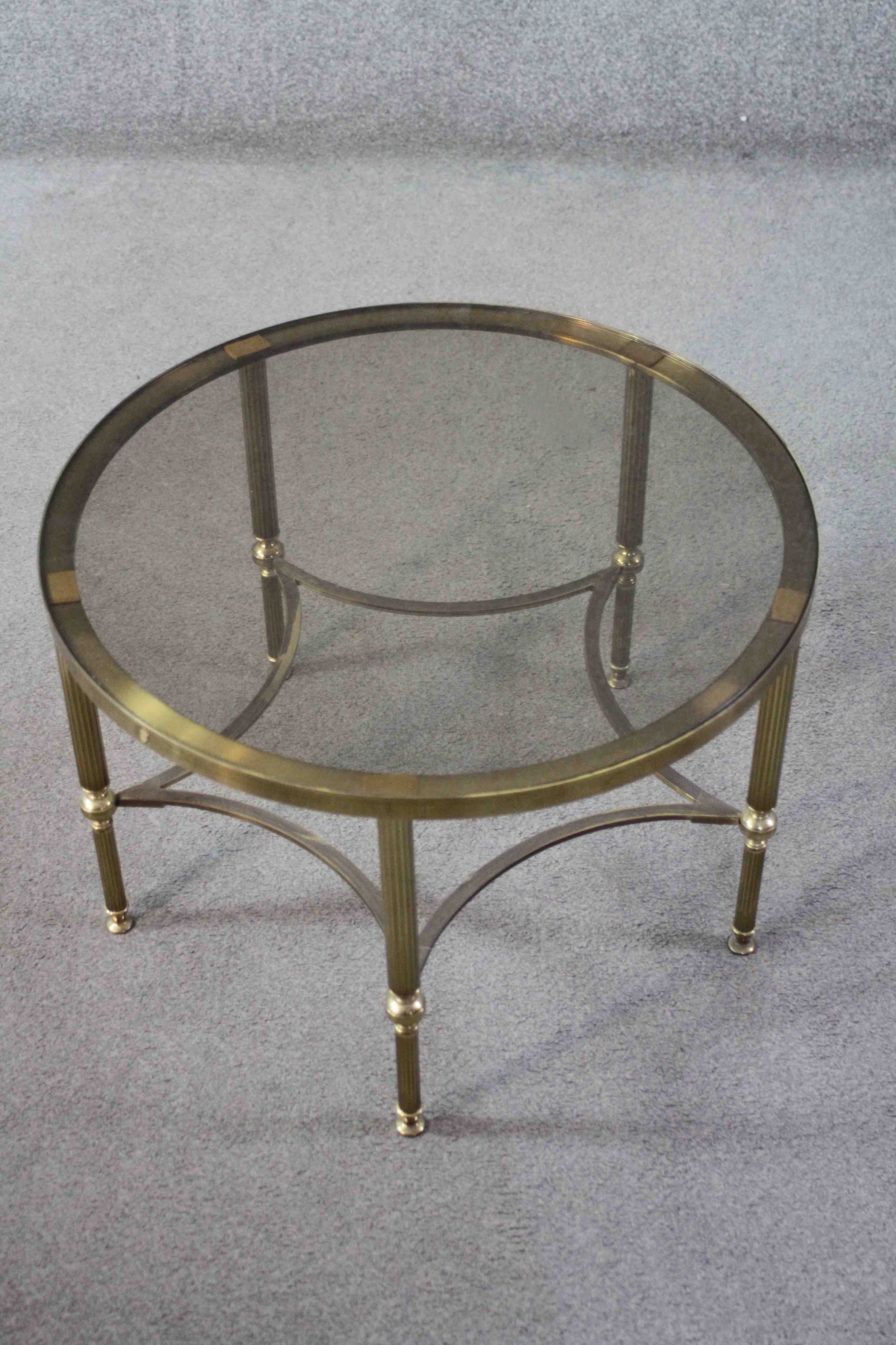 A mid century vintage smoked glass and brass lamp table on shaped stretchered supports. H.40 Diam. - Image 2 of 4