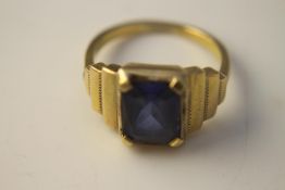 A yellow metal (tests as 14 carat) dress ring with stepped shoulders, set to centre with an