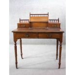 A late 19th century walnut writing table with raised superstructure fitted with stationery