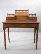 A late 19th century walnut writing table with raised superstructure fitted with stationery