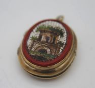 A 14 carat gold locket with engraved vase of flowers to the back and micro mosaic panel to the front