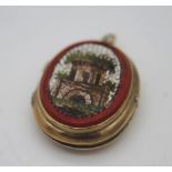 A 14 carat gold locket with engraved vase of flowers to the back and micro mosaic panel to the front