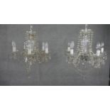 A pair of vintage cut crystal five branch chandeliers with hanging crystal drops and swags. H.33 W.