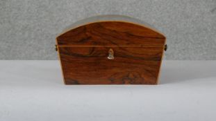 A Regency rosewood domed top jewellery casket with satinwood and ebony stringing and twin turned