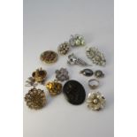 A collection of jewellery. Including A silver heart shaped signet ring, a carved bog oak rose