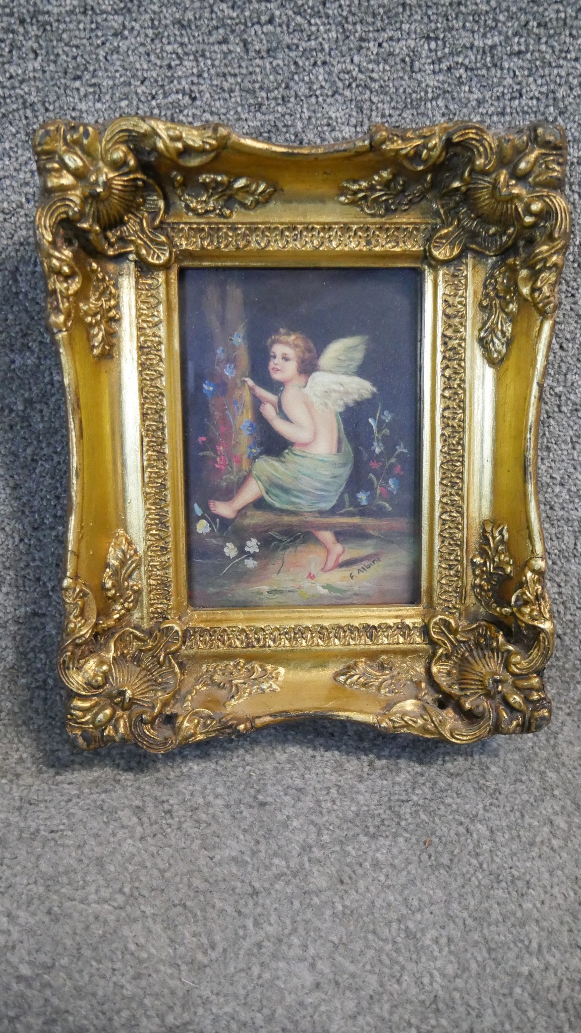 A 19th century carved gilt framed oil on board of a winged putti sitting in a wood with flowers. - Image 4 of 5