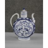 A large Chinese Qianlong style blue and white lidded ewer, decorated with dragons. Character mark to
