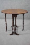 A Victorian mahogany drop flap Sutherland table on turned tapering gateleg supports. H.56 W.54 D.