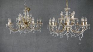 A pair of vintage brass and cut crystal twelve branch chandeliers with crystal swags and drops. H.
