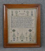 A framed and glazed Victorian hand embroidered sampler by Amelia Eliza Cox at the age of ten.