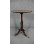 A 19th century mahogany occasional table on ring turned central column resting on swept tripod base.