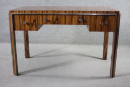 An Art Deco macassar ebony writing table with chrome mounts and fittings and central frieze drawer
