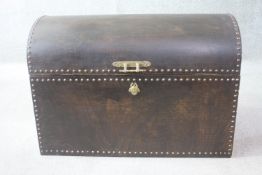 A wooden traveling trunk with brass fittings and green fabric interior. H.63 W.92 D.46. cm