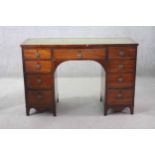 A 19th century mahogany pedestal desk with inset green tooled leather top above an arrangement of