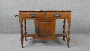 A late 19th century walnut washstand with veined rouge marble top above frieze drawers on turned