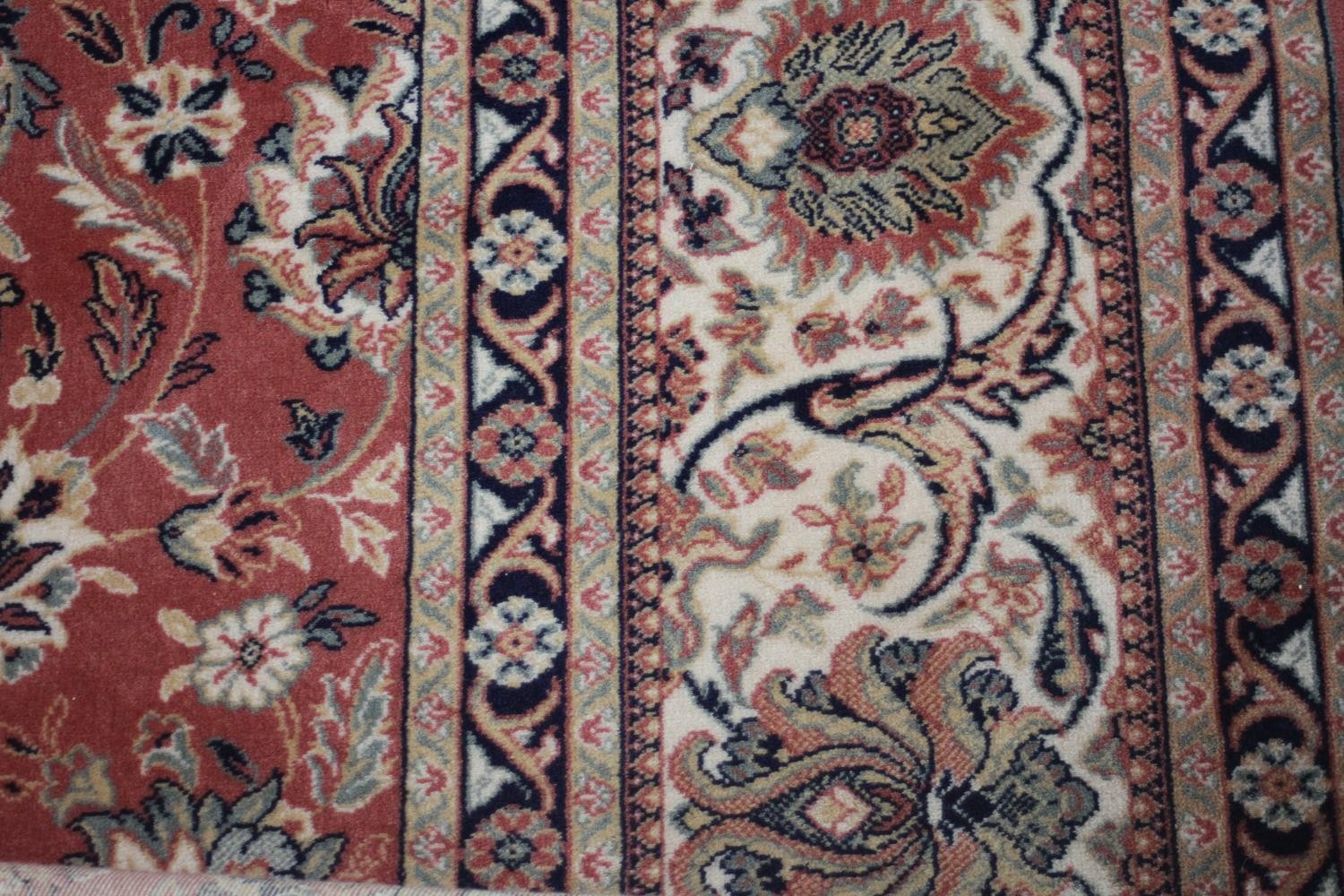 A Keshan motif woollen carpet with central medallion and trailing foliate pattern on a burgundy - Image 3 of 5