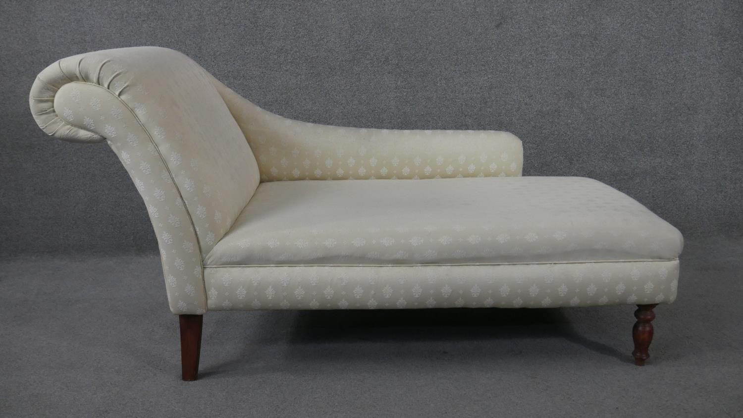 A Victorian style chaise in floral damask upholstery on turned baluster supports. H.80 W.142 D.66cm