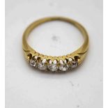 A Victorian 18 carat yellow gold five stone old cut diamond carved half hoop ring. Set with five