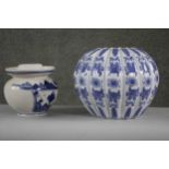 Two Chinese porcelain blue and white pieces. One gourd shaped foliate design vase along with a