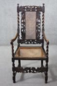 A late 19th century carved oak armchair with caned back and seat on stretchered barleytwist