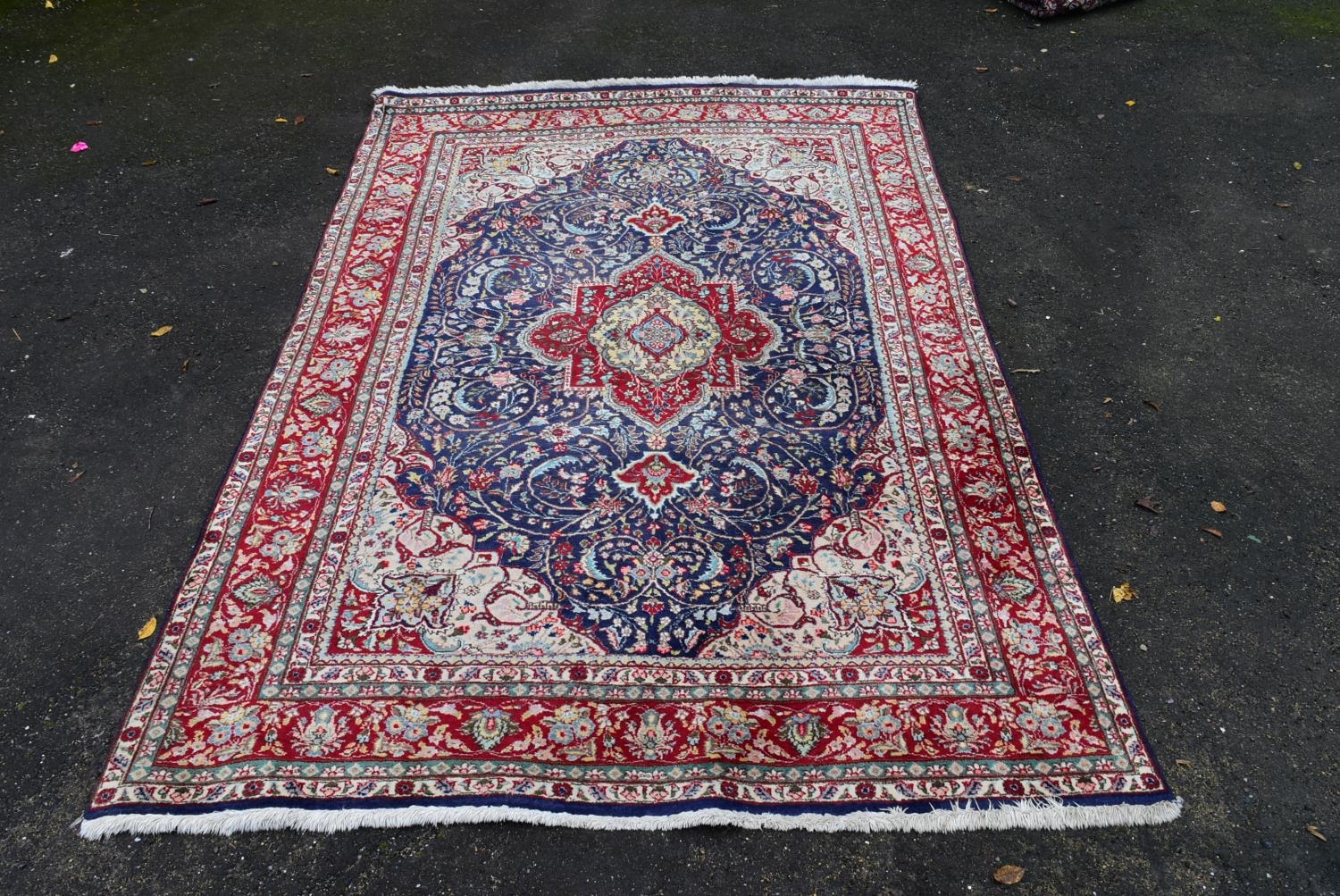 A Persian Keshan carpet with central floral medallion on sapphire ground within foliate multiple - Image 2 of 4