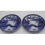 A pair of Japanese Arita style porcelain blue and white chargers hand painted with a landscape