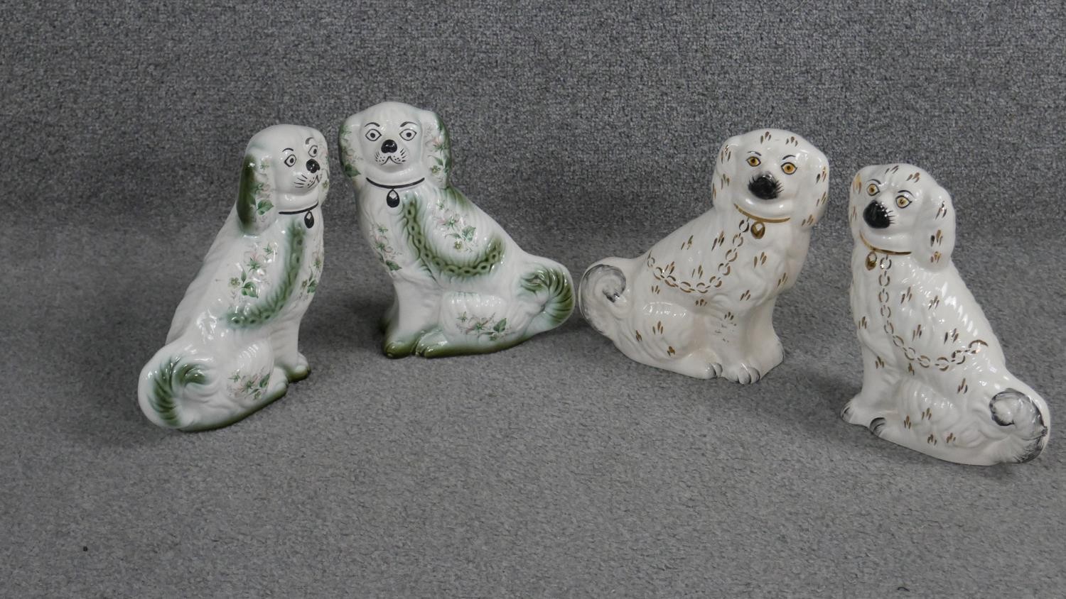 Two pairs of Staffordshire style ceramic spaniels. One pair with Blakeney stamp to bases. H.21 W.