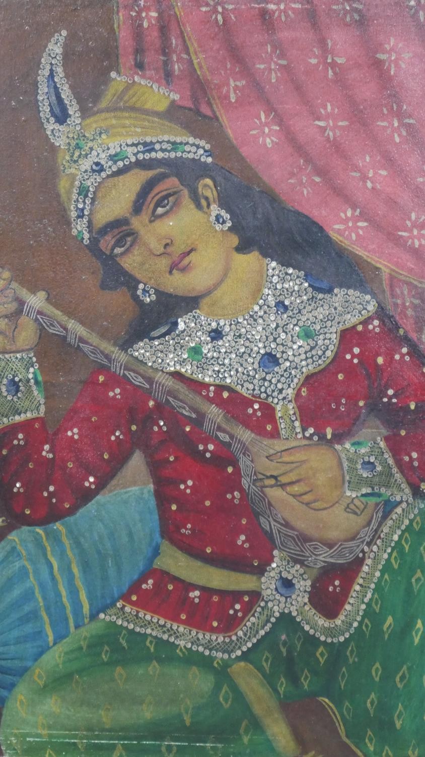 A 20th century oil on board of a seated Indian female in traditional dress playing a sitar. H.69 W.