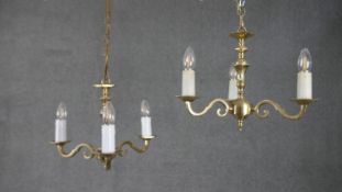 A pair of vintage brass three branch scrolling design candelabras. H.30 W.40cm