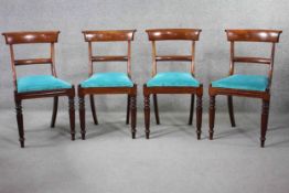 A set of four early 19th century mahogany bar back dining chairs with drop in seats above tapering