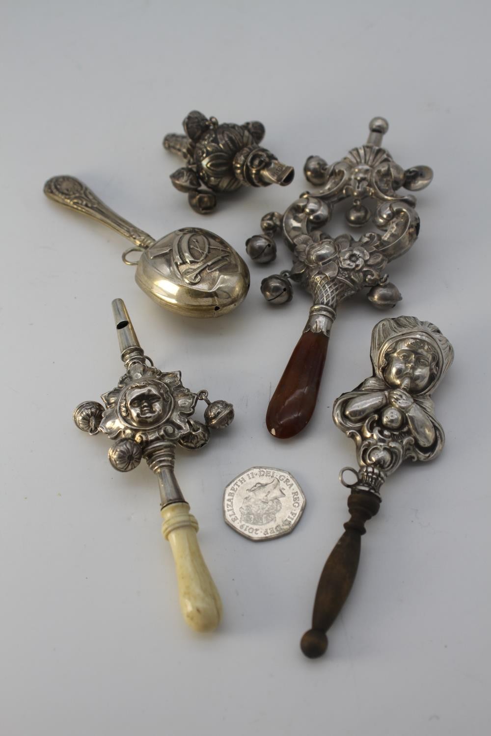 Five silver rattles. Including a Danish drum and trumpet design rattle, one in the form of a young - Image 6 of 6